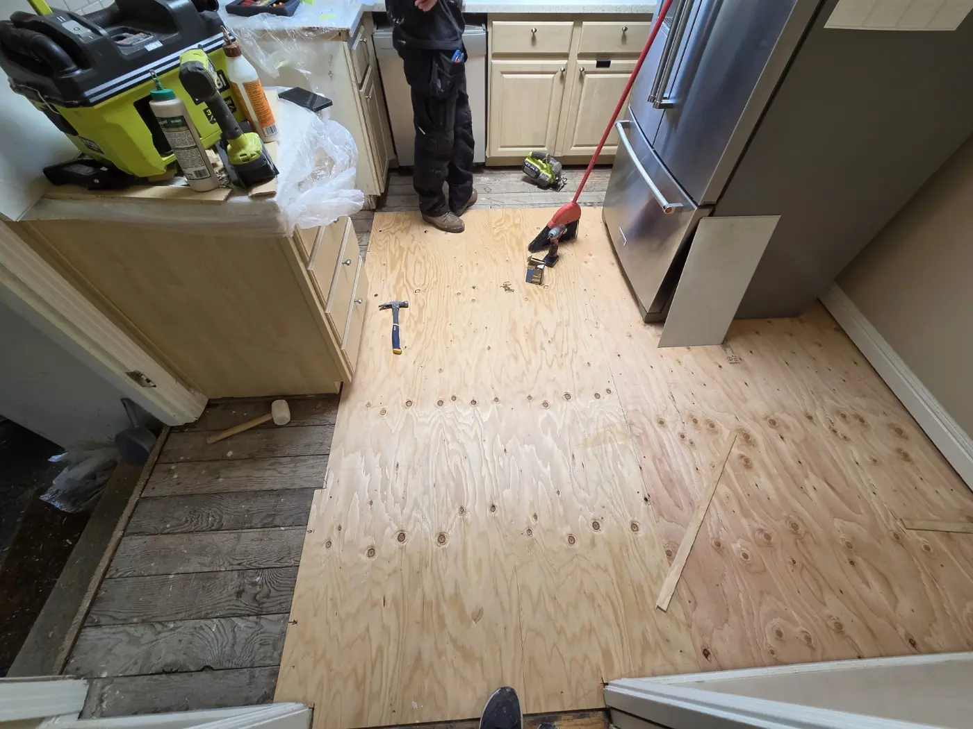 Plywood subfloor preparation before kitchen vinyl plank installation