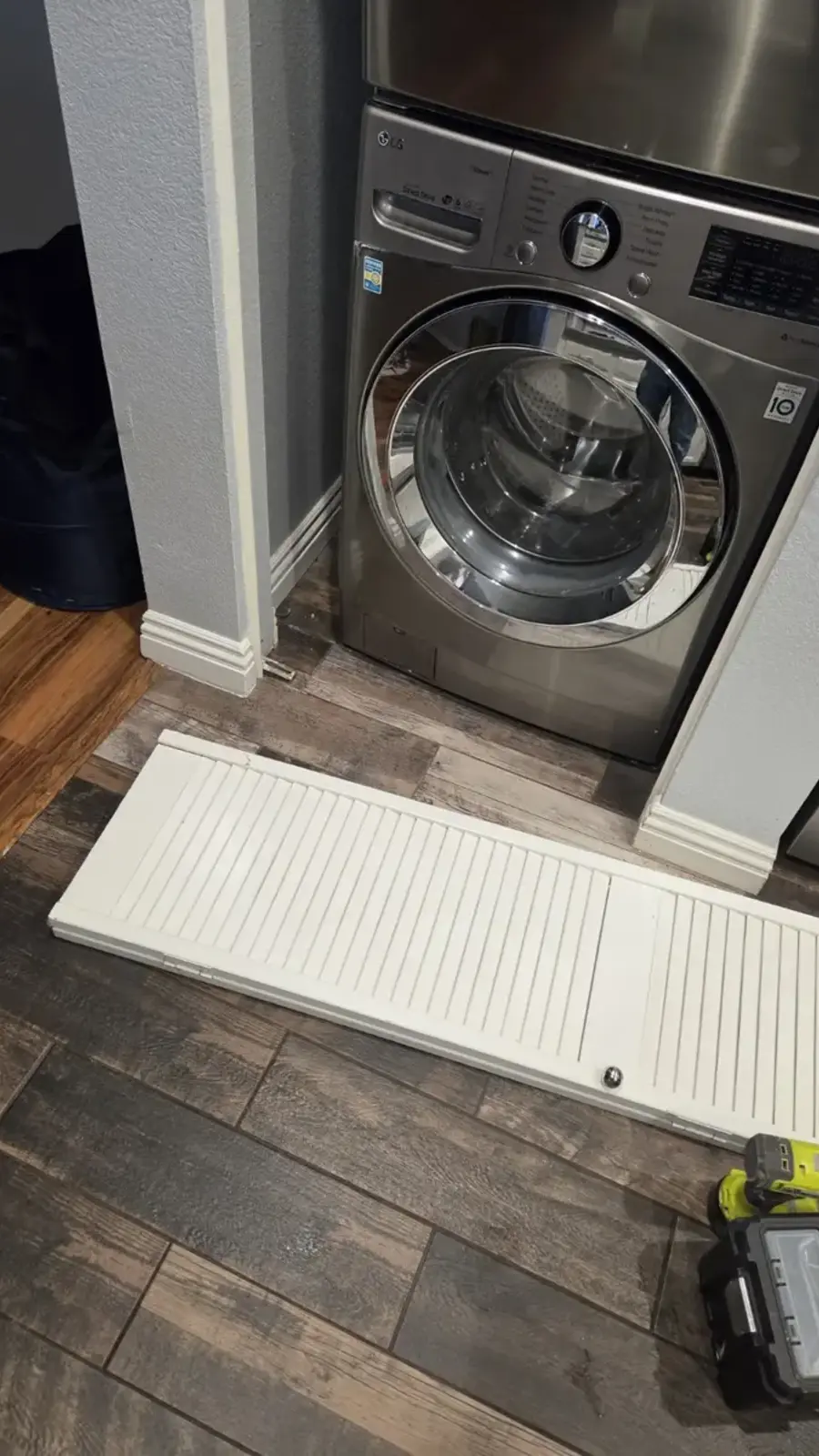 Louvered bi-fold laundry closet door panels prepared for installation